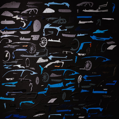 Collection of blue car model panels and parts on a black background