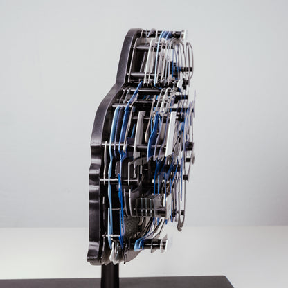 Side view of a blue model car on a gray background