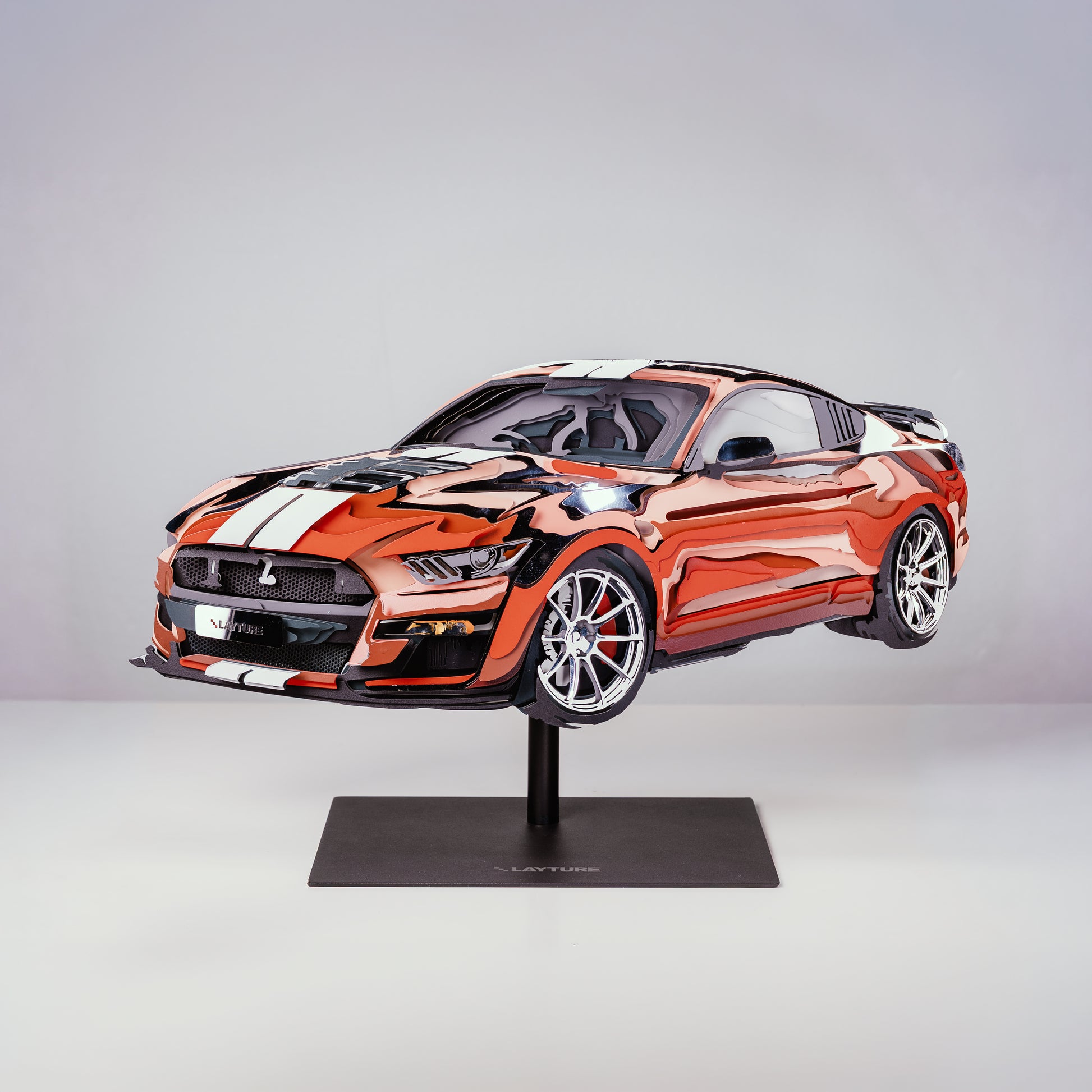 Model car on a stand with a gray background