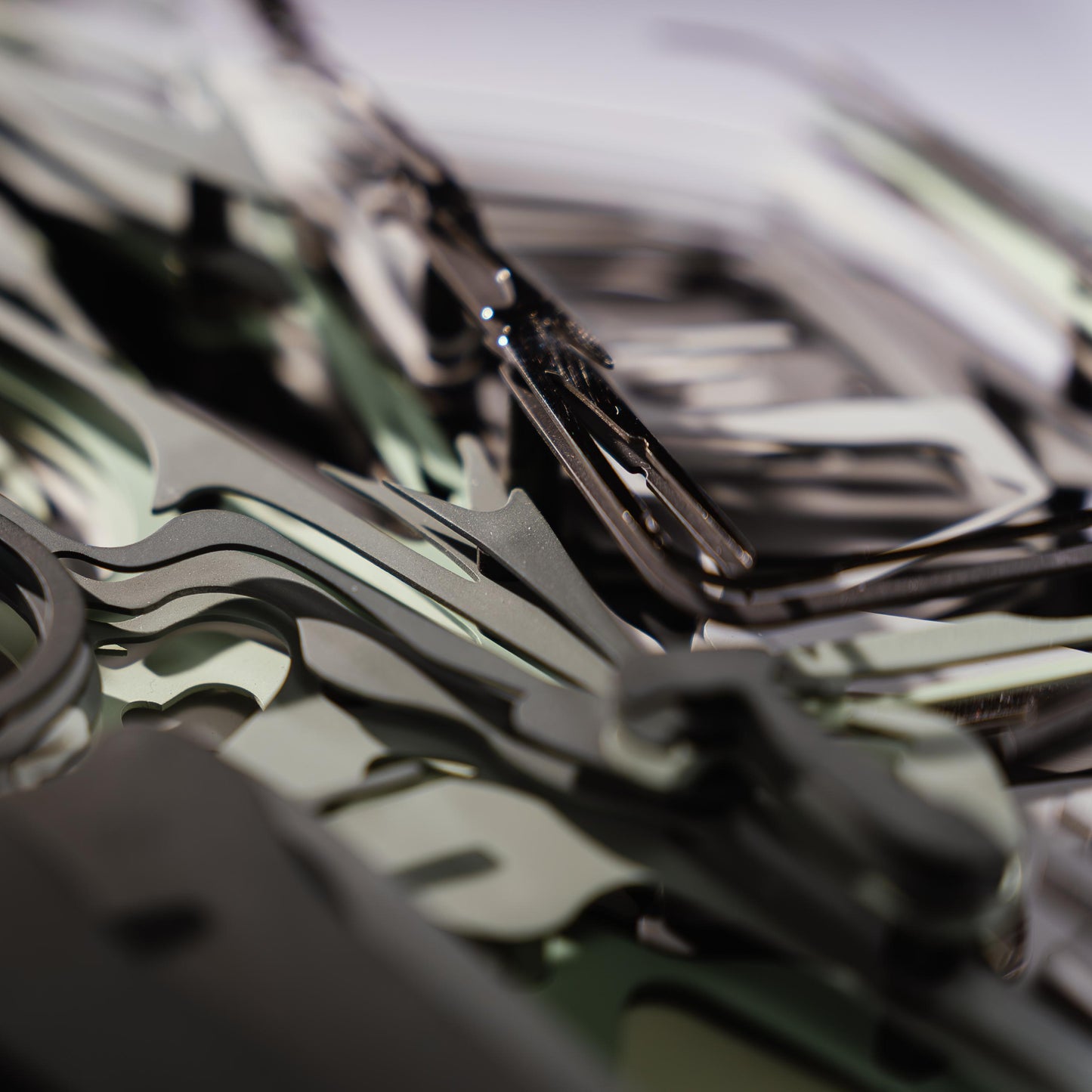 Close-up of a green car model with lots of metal connectors with a blurred background