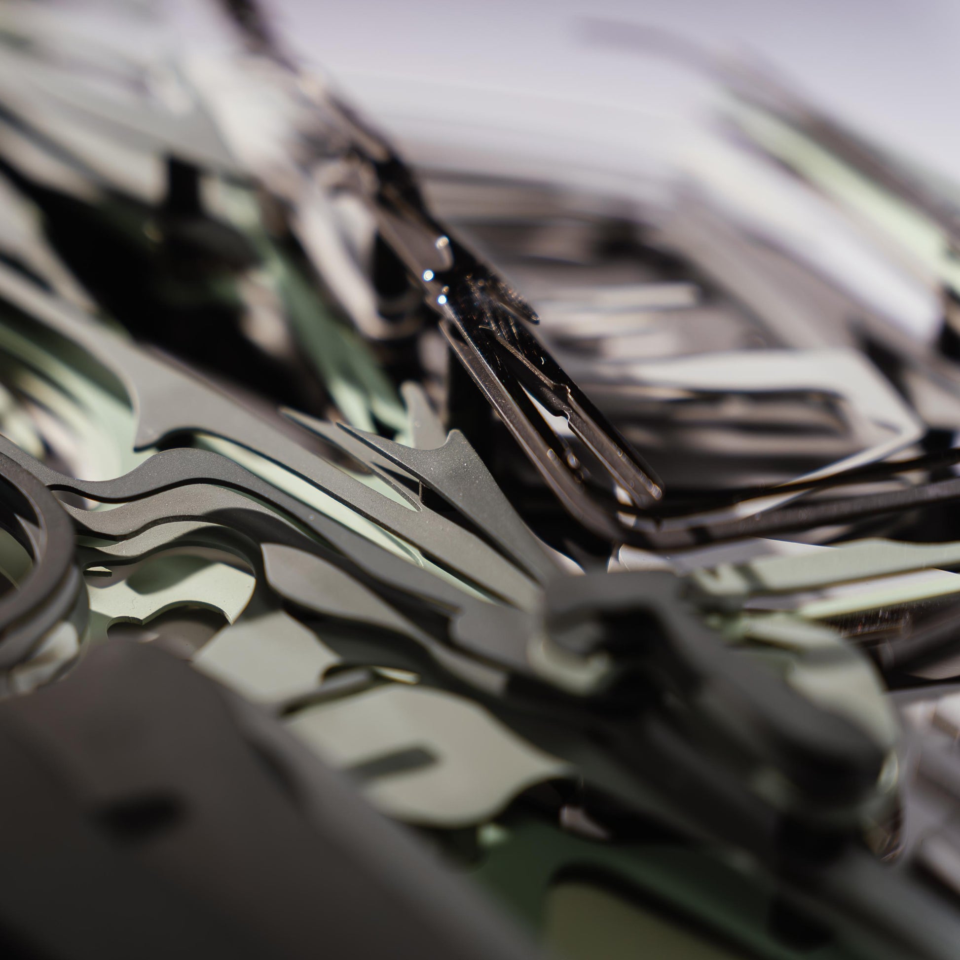 Close-up of a green car model with lots of metal connectors with a blurred background