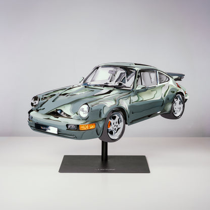 Model of a green sports car on a stand against a gray background