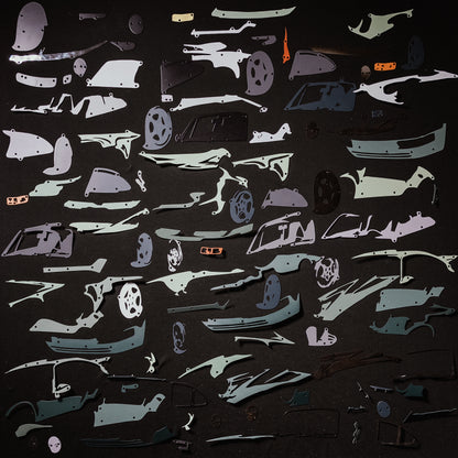 Collection of green car model panels and parts on a black background