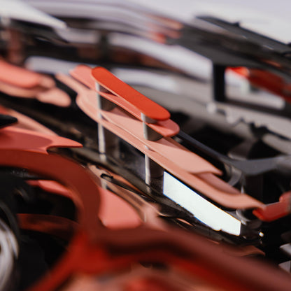 Close-up of a red car model with lots of metal connectors with a blurred background