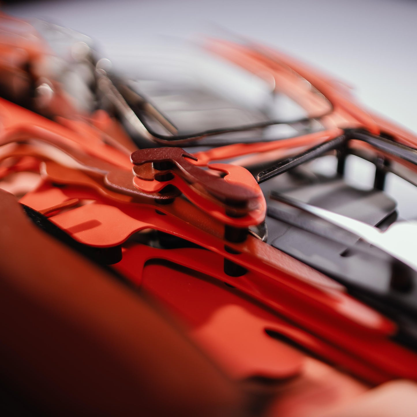Close-up of a red car model with a blurred background