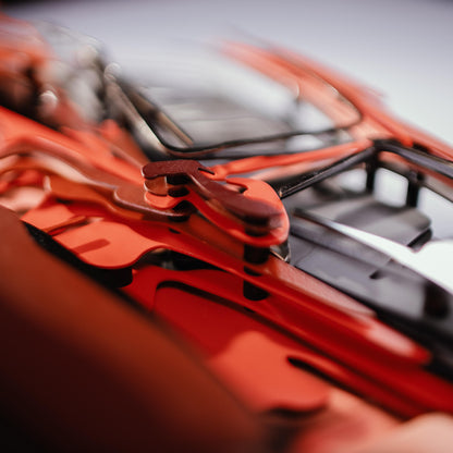 Close-up of a red car model with a blurred background